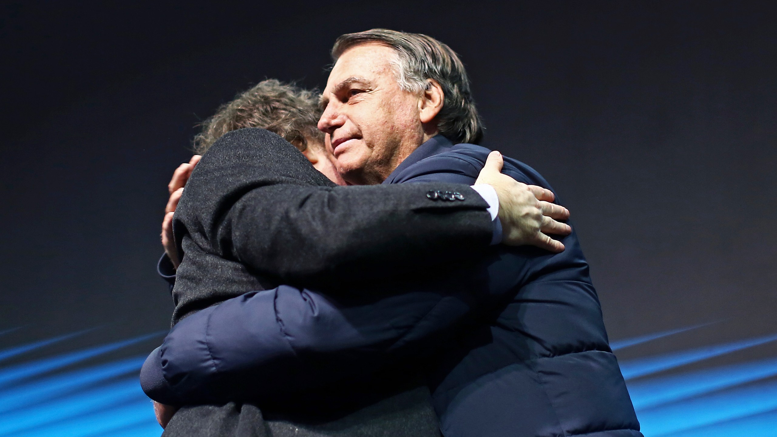 Brazil's former President Jair Bolsonaro, right, hugs Argentina's President Javier Milei at CPAC Brasil 2024, a conservative event, in Balneario Camboriu, Santa Catarina state, Brazil, Sunday, July 7, 2024. (AP Photo/Heuler Andrey)