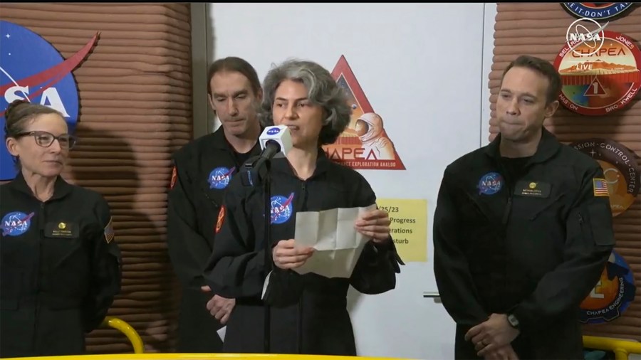 In this image made from video provided by NASA, Anca Selariu, a crew member of the first CHAPEA mission, speaks in front of other members, from left to right, Kelly Haston, Ross Brockwell, and Nathan Jones, Saturday, July 6, 2024, at Johnson Space Center in Houston, Texas. The crew of a NASA mission to Mars emerged from their craft after a yearlong voyage that never left Earth. The four volunteers crew members spent more than 12 months inside NASA's first simulated Mars environment at Johnson Space Center in Houston, coming out of the artificial alien environment Saturday. (NASA via AP)