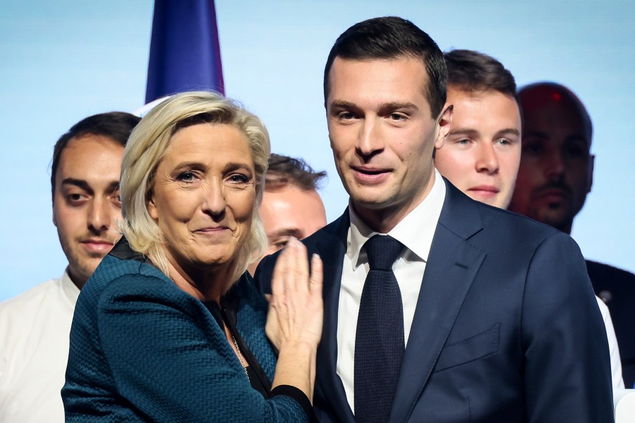 FILE - Leader of the French far-right National Rally Marine Le Pen, left, and lead candidate of the party for the upcoming European election Jordan Bardella during a political meeting on June 2, 2024 in Paris. Jordan Bardella, Le Pen's 28-year-old protégé who she'd been hoping to install as prime minister, grumbled that "the alliance of dishonor" between the National Rally's rivals kept it from power. (AP Photo/Thomas Padilla, File)