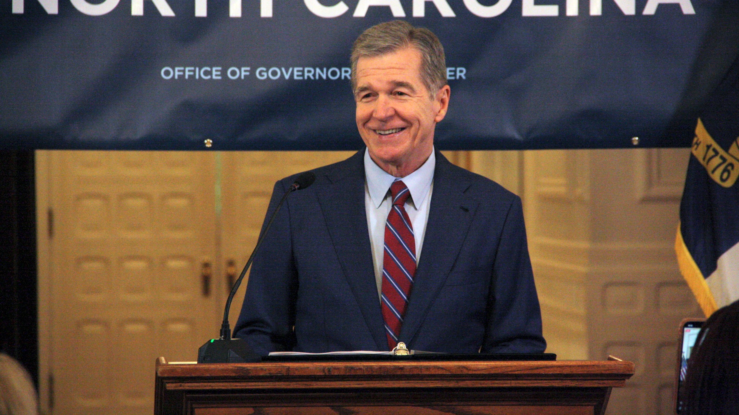 North Carolina Gov. Roy Cooper touts Medicaid expansion reaching 500,000 enrollees during a news conference at the North Carolina Executive Mansion in Raleigh, N.C., on Friday, July 12, 2024. It took about seven months to reach 500,000 enrollees, which Cooper said exceeded his office's expectations. (AP Photo/Makiya Seminera)