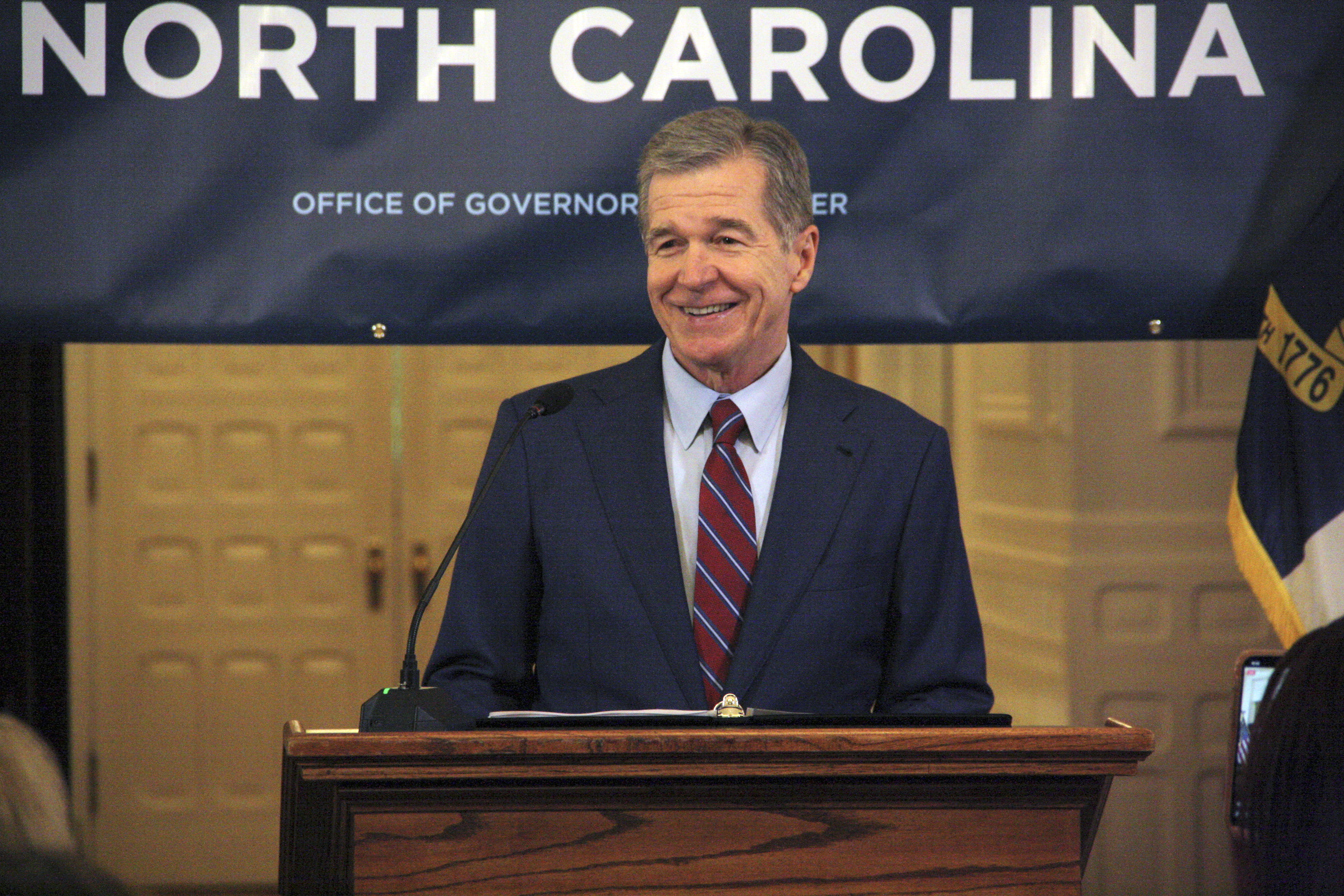 North Carolina Gov. Roy Cooper touts Medicaid expansion reaching 500,000 enrollees during a news conference at the North Carolina Executive Mansion in Raleigh, N.C., on Friday, July 12, 2024. It took about seven months to reach 500,000 enrollees, which Cooper said exceeded his office's expectations. (AP Photo/Makiya Seminera)