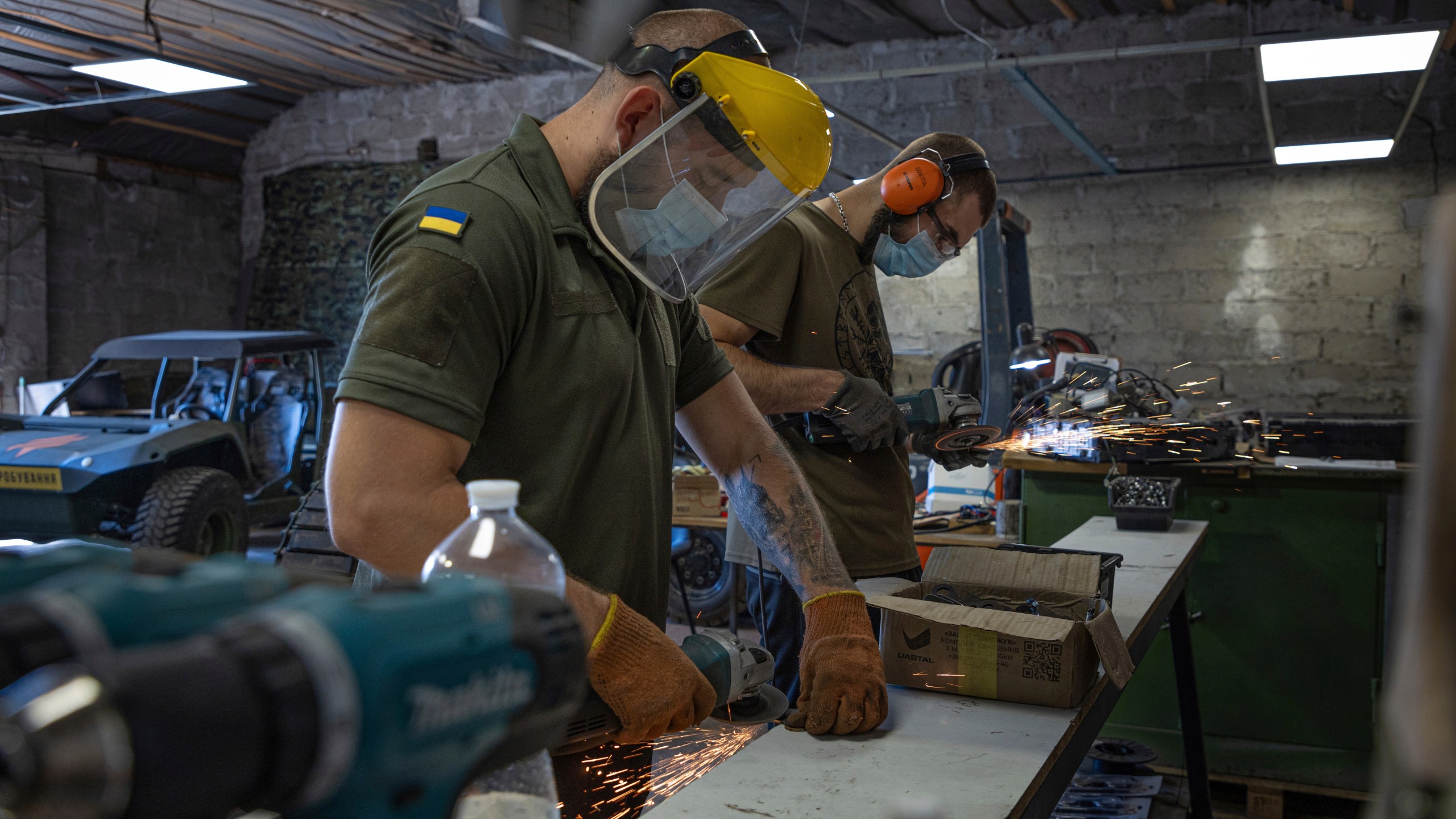 Engineers of design and production bureau "UkrPrototyp" work on new parts for a ground drone, in northern Ukraine, Thursday, June 27, 2024. Facing manpower shortages and uneven international assistance, Ukraine is struggling to halt Russia’s incremental but pounding advance in the east and is counting heavily on innovation at home. (AP Photo/Anton Shtuka)