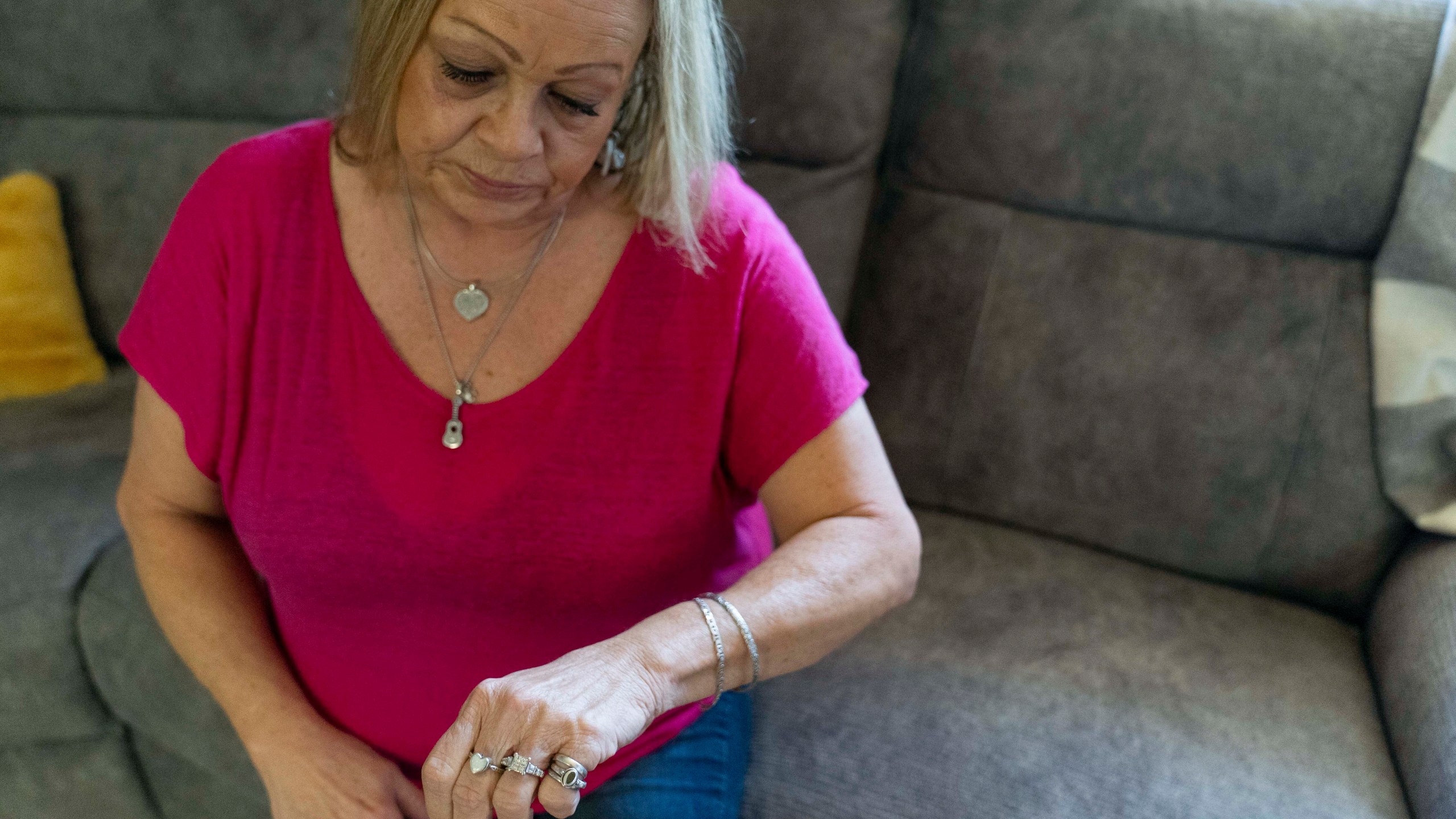 Lori Ellinger wears a heart-shaped ring that holds the ashes of her late son, Trea Ellinger, Monday, July 1, 2024, in her home in Glen Burnie, Md. (AP Photo/Stephanie Scarbrough)