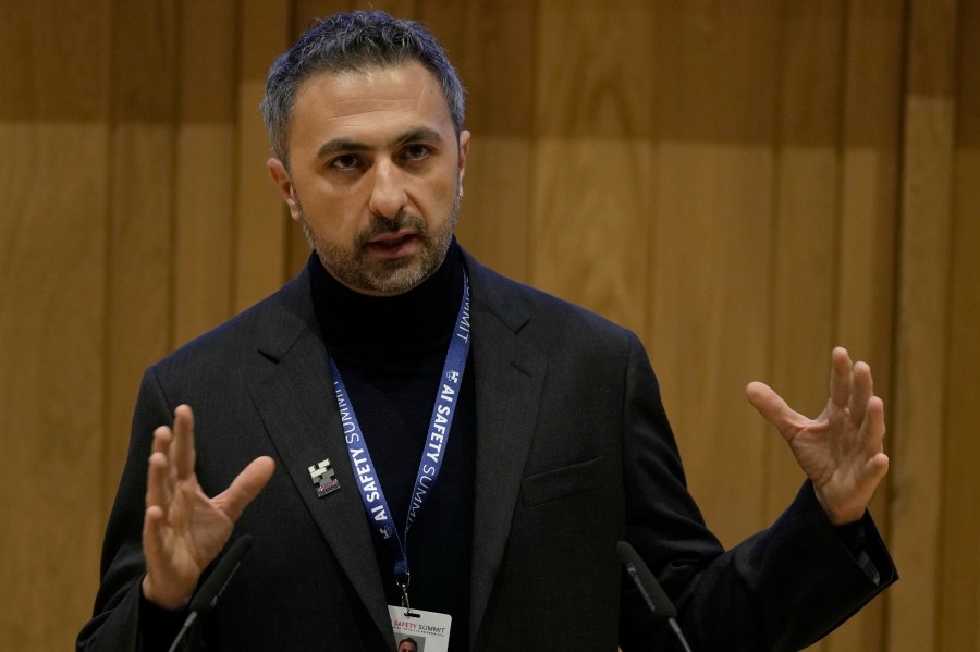 FILE - Mustafa Suleyman co founder and CEO of Inflection AI speaks to journalist during the AI Safety Summit in Bletchley Park, Milton Keynes, England, on Nov. 1, 2023. The Competition and Markets Authority said Tuesday, July 16, 2024 that its review of the hirings from Inflection AI turned up “sufficient information” to open an investigation. Microsoft hired Inflection's co-founder and CEO Mustafa Suleyman to head up its consumer artificial intelligence business, along with several top engineers and researchers. (AP Photo/Alastair Grant)