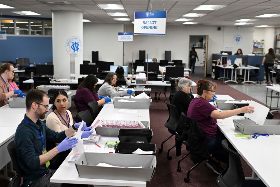 FILE - County employees open ballots in the ballot opening area of the mail ballot processing room at the Washoe County Registrar of Voters office in Reno, Nev., June 3, 2024. Commissioners in Nevada's second most populous county certified the results of two local recounts on Tuesday, July 16, reversing course on a controversial vote against certification that spurred legal action and put Washoe County in unchartered legal territory. (AP Photo/Andy Barron, File)