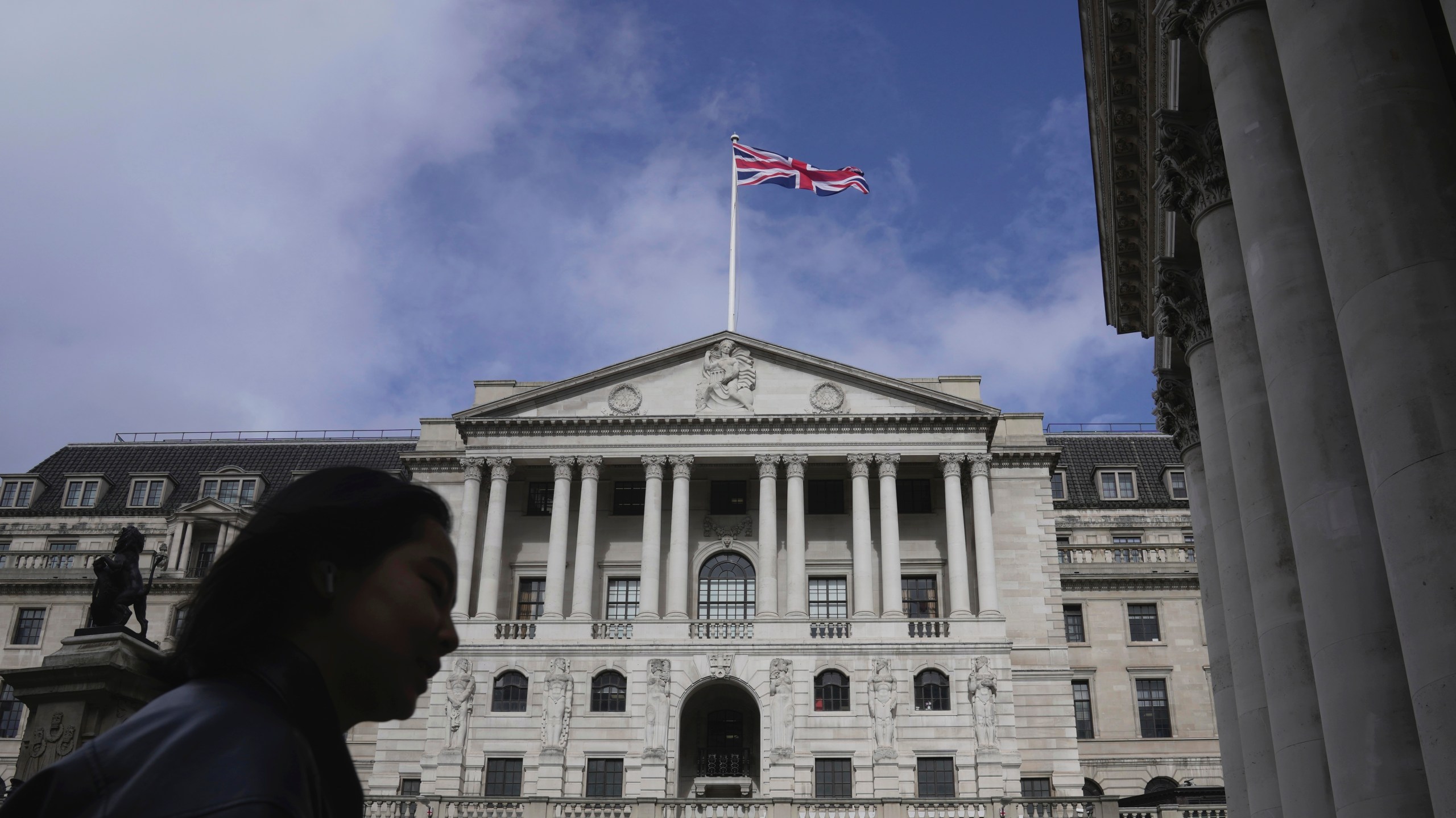 FILE - A woman walks in front of the Bank of England, at the financial district in London, on March 23, 2023. Inflation in the U.K. held steady at the Bank of England's target rate of 2% in the year to June, official figures showed Wednesday, July 17, 2024, in a development that could be enough for policymakers to cut borrowing costs next month. (AP Photo/Kin Cheung, File)