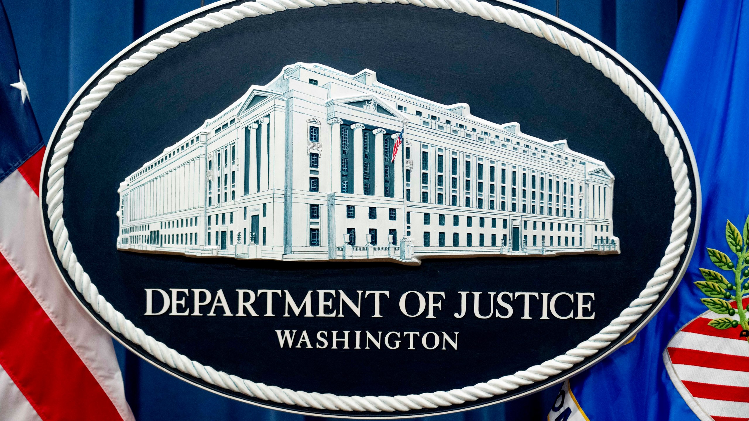 FILE - A U.S. Department of Justice sign is seen, Nov. 18, 2022, in Washington. The U.S. Justice Department says a former CIA employee and senior official at the National Security Council has been charged with serving as a secret agent for South Korea’s intelligence service. (AP Photo/Andrew Harnik, File)