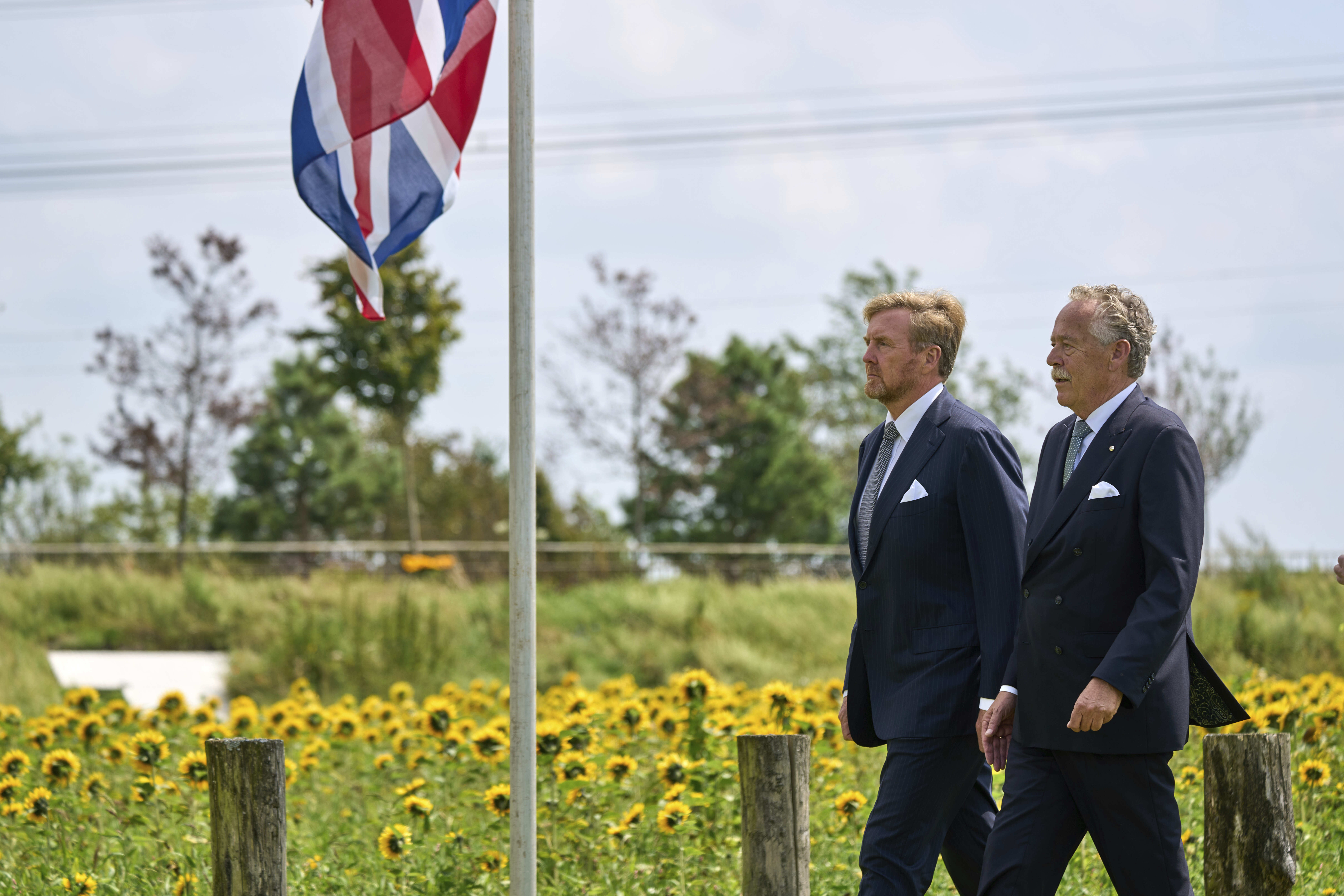 Dutch King Willem Alexander, left, arrives with Piet Ploeg, to attend a commemoration at the national monument in Vijfhuizen, Netherlands, Wednesday July 17, 2024, to mark the tenth anniversary of the downing of flight MH17 in eastern Ukraine, which killed all 298 people on board. (AP Photo/Phil Nijhuis)