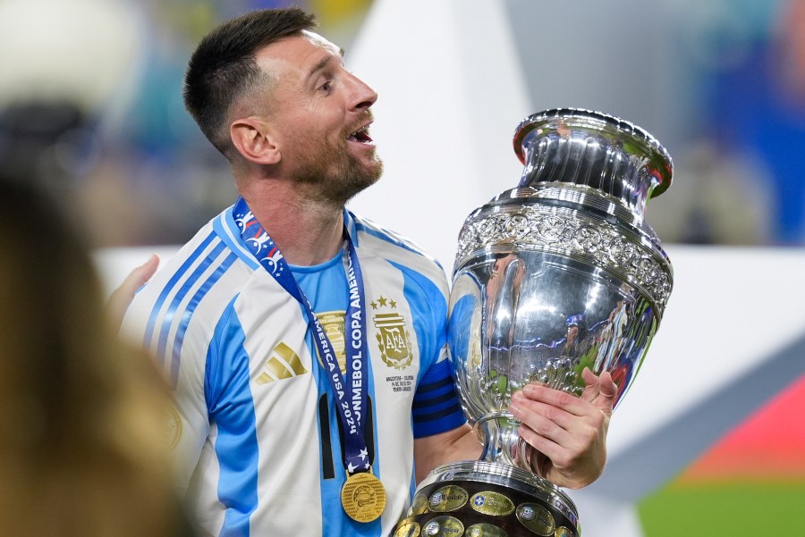 Argentina's Lionel Messi celebrates with the trophy after his team defeated Colombia in the Copa America final soccer match in Miami Gardens, Fla., Monday, July 15, 2024. (AP Photo/Rebecca Blackwell)