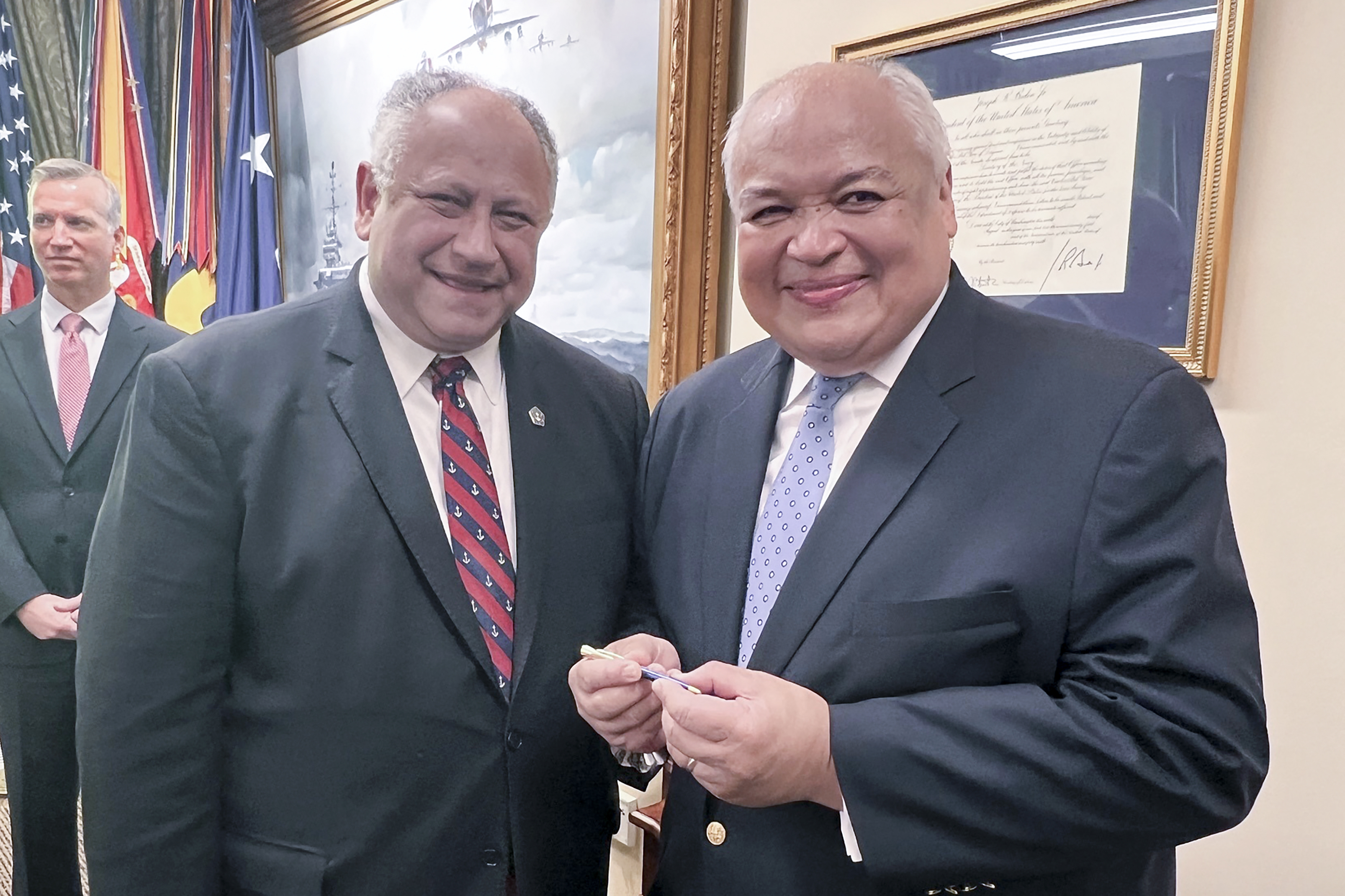 Thurgood Marshall, Jr., right, smiles as he receives the first pen from Navy Secretary Carlos Del Toro, Wednesday, July 17, 2024 at the Pentagon in Washington, after it was used to sign documents exonerating 256 Black sailors who were unjustly court martialed in 1944 after the horrific Port Chicago explosion in California. (AP Photo/Tara Copp)