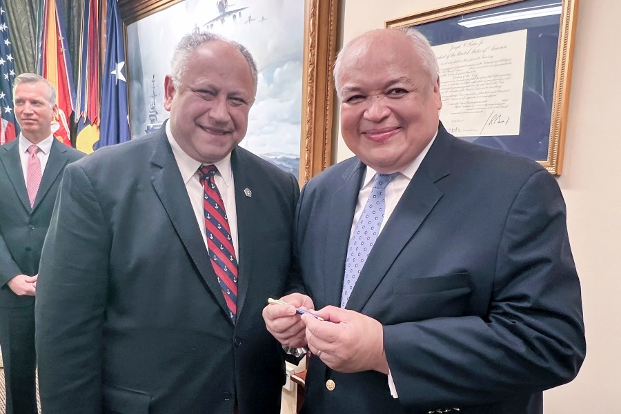 Thurgood Marshall, Jr., right, smiles as he receives the first pen from Navy Secretary Carlos Del Toro, Wednesday, July 17, 2024 at the Pentagon in Washington, after it was used to sign documents exonerating 256 Black sailors who were unjustly court martialed in 1944 after the horrific Port Chicago explosion in California. (AP Photo/Tara Copp)