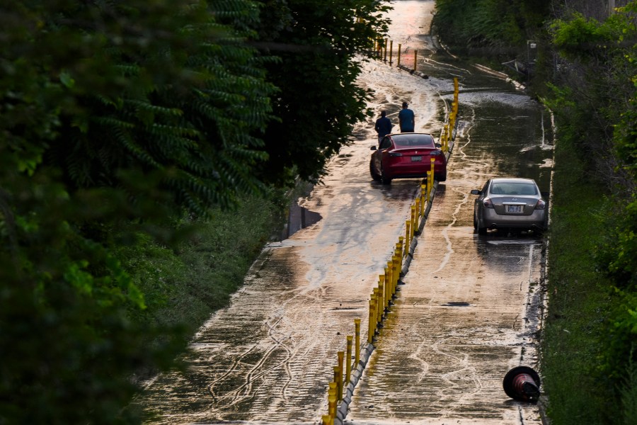 Cars remain stranded on Bayview Avenue as water recedes following heavy rain that caused flooding in Toronto on Tuesday, July 16, 2024. (Christopher Katsarov/The Canadian Press via AP)