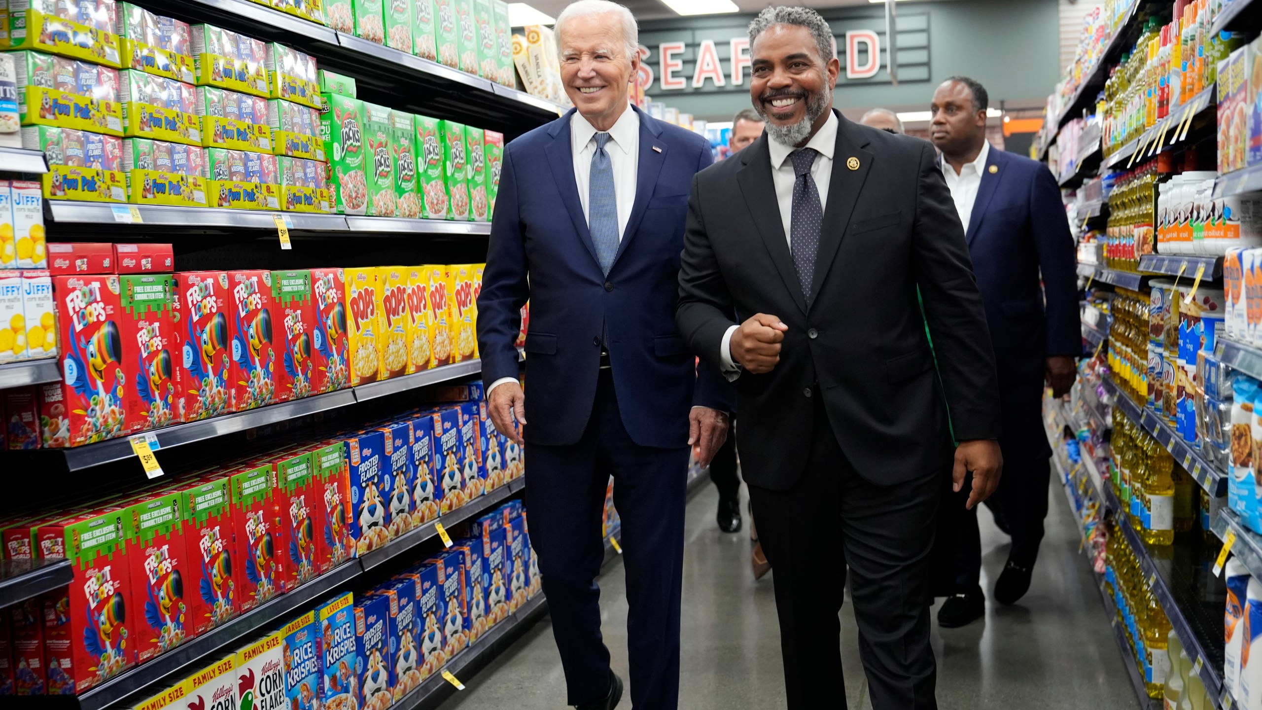 President Joe Biden walks with Rep. Steve Horsford, D-Nev., as he visits Mario's Westside Market in Las Vegas, Tuesday, July 16, 2024. (AP Photo/Susan Walsh)