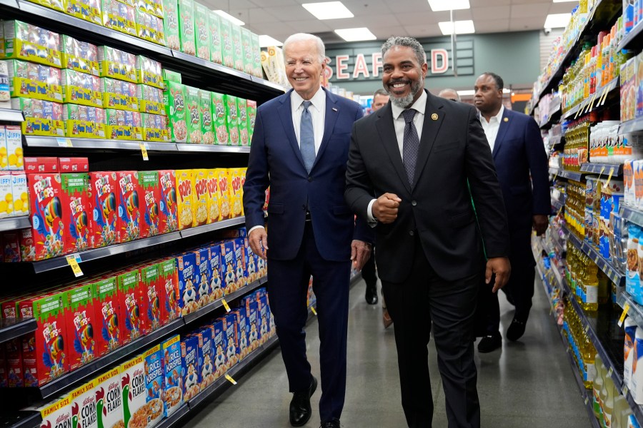 President Joe Biden walks with Rep. Steve Horsford, D-Nev., as he visits Mario's Westside Market in Las Vegas, Tuesday, July 16, 2024. (AP Photo/Susan Walsh)