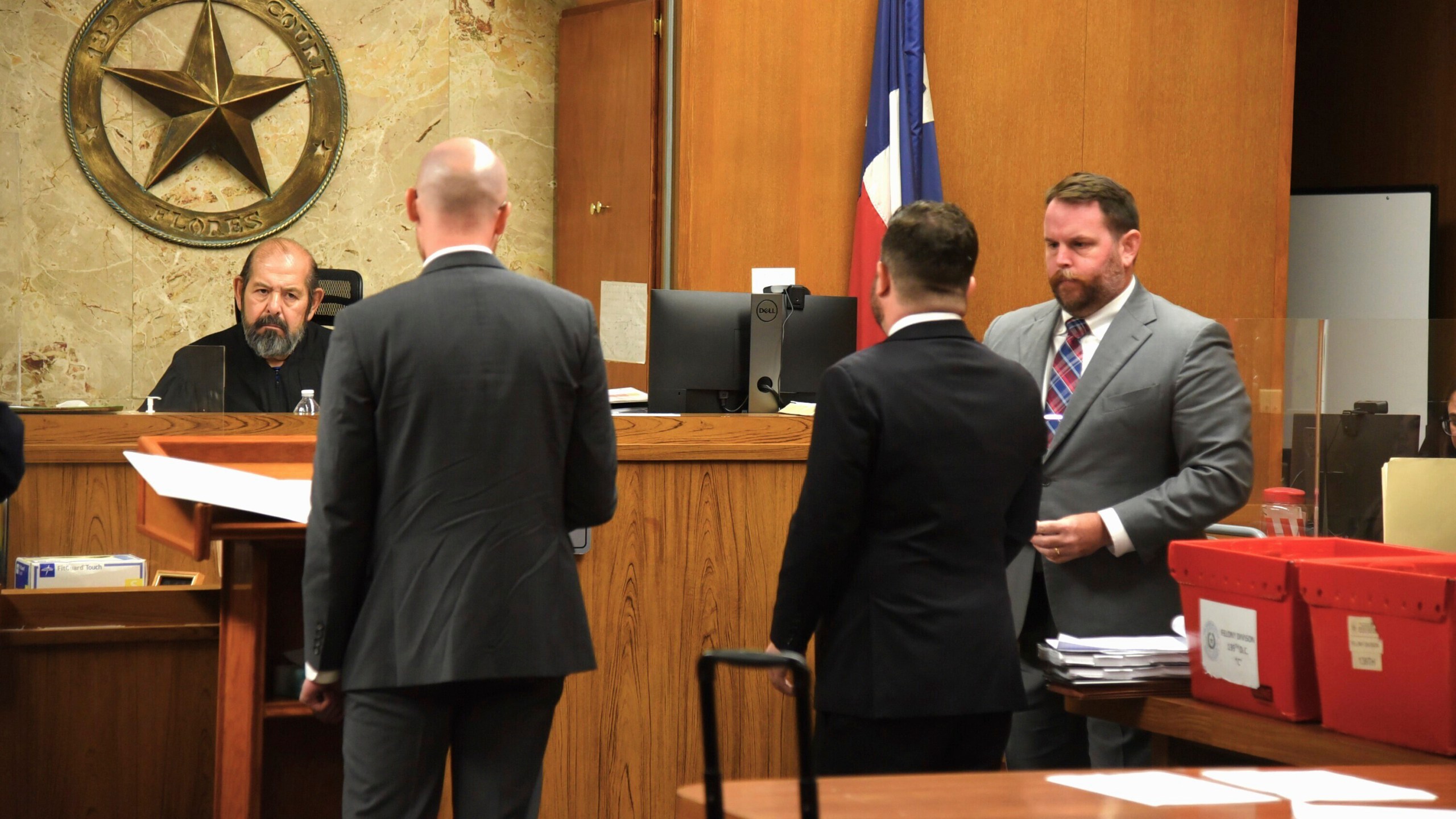 Texas state District Judge J.R. Flores hears arguments from Catholic Charities attorney William Powell, second left, as Matthew Kennedy and Levi Fuller with the Texas attorney general's office listen on Wednesday, July 17, 2024, in Edinburg, Texas. Catholic Charities is asking the court to prevent the state from deposing one of the organization's leaders. (AP Photo/Valerie Gonzalez)