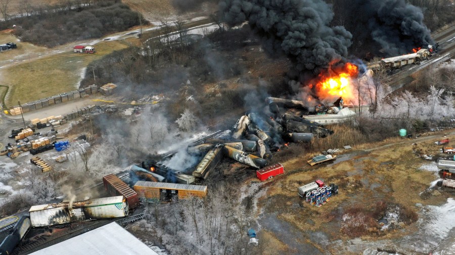 FILE - Debris from a Norfolk Southern freight train lies scattered and burning along the tracks Feb. 4, 2023, the day after it derailed in East Palestine, Ohio. The EPA's Inspector General announced Tuesday, July 16, 2024, an investigation into why the agency didn't get its specialized plane loaded with advanced sensors into the air over East Palestine until four days after the derailment last year. (AP Photo/Gene J. Puskar, File)