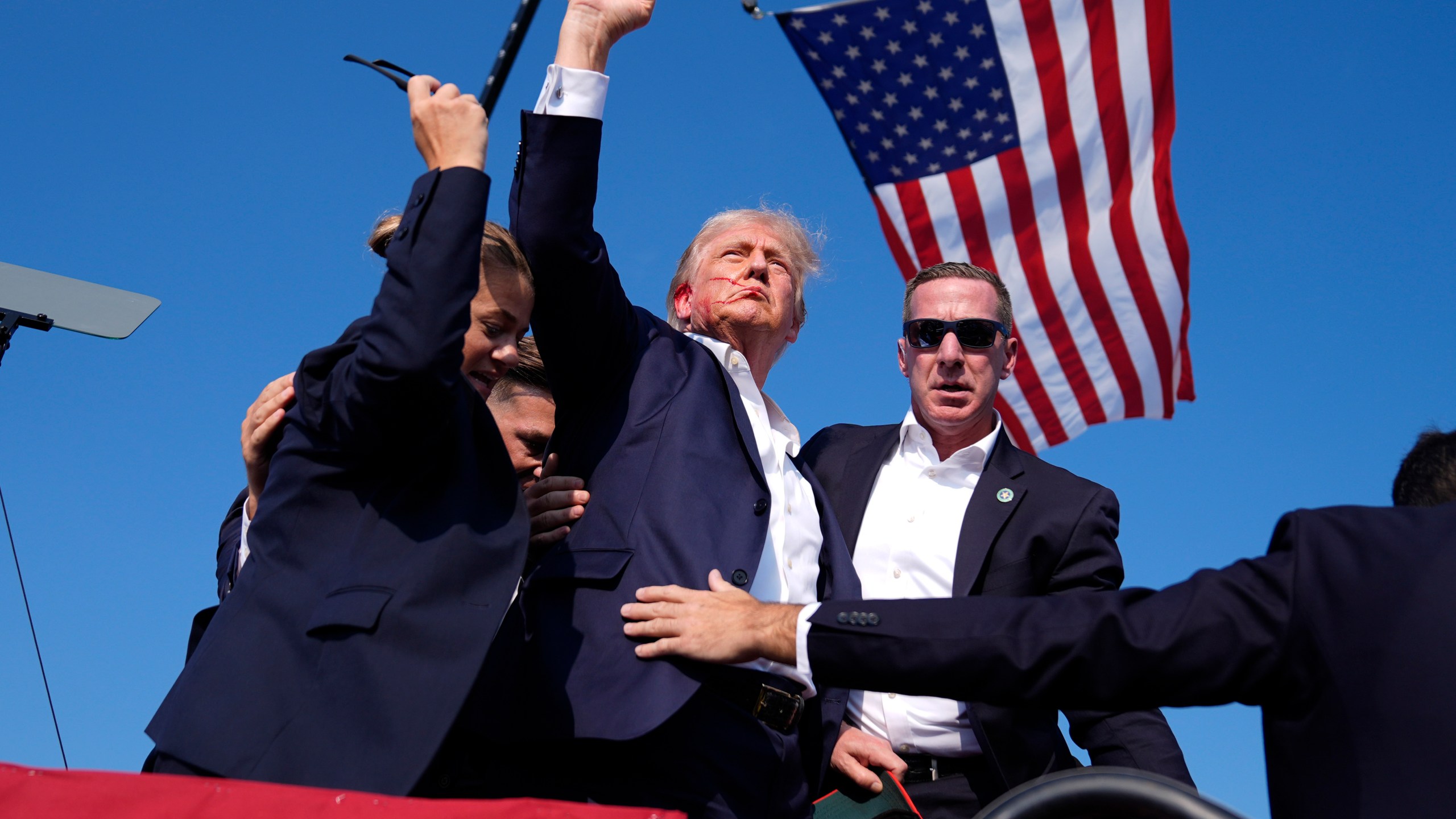 FILE - Republican presidential candidate former President Donald Trump gestures as he is surrounded by U.S. Secret Service agents as he leaves the stage at a campaign rally, July 13, 2024, in Butler, Pa. (AP Photo/Evan Vucci, File)