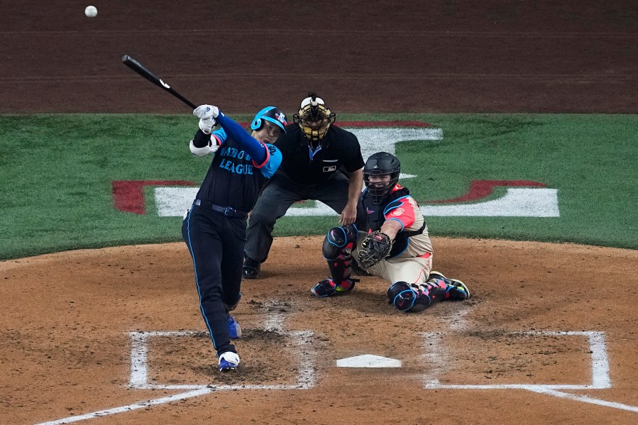 National League's Shohei Ohtani, of the Los Angeles Dodgers, hits a home run during the third inning of the MLB All-Star baseball game, Tuesday, July 16, 2024, in Arlington, Texas. Jurickson Profar, of the San Diego Padres, and Ketel Marte, of the Arizona Diamondbacks, also scored. (AP Photo/Tony Gutierrez)