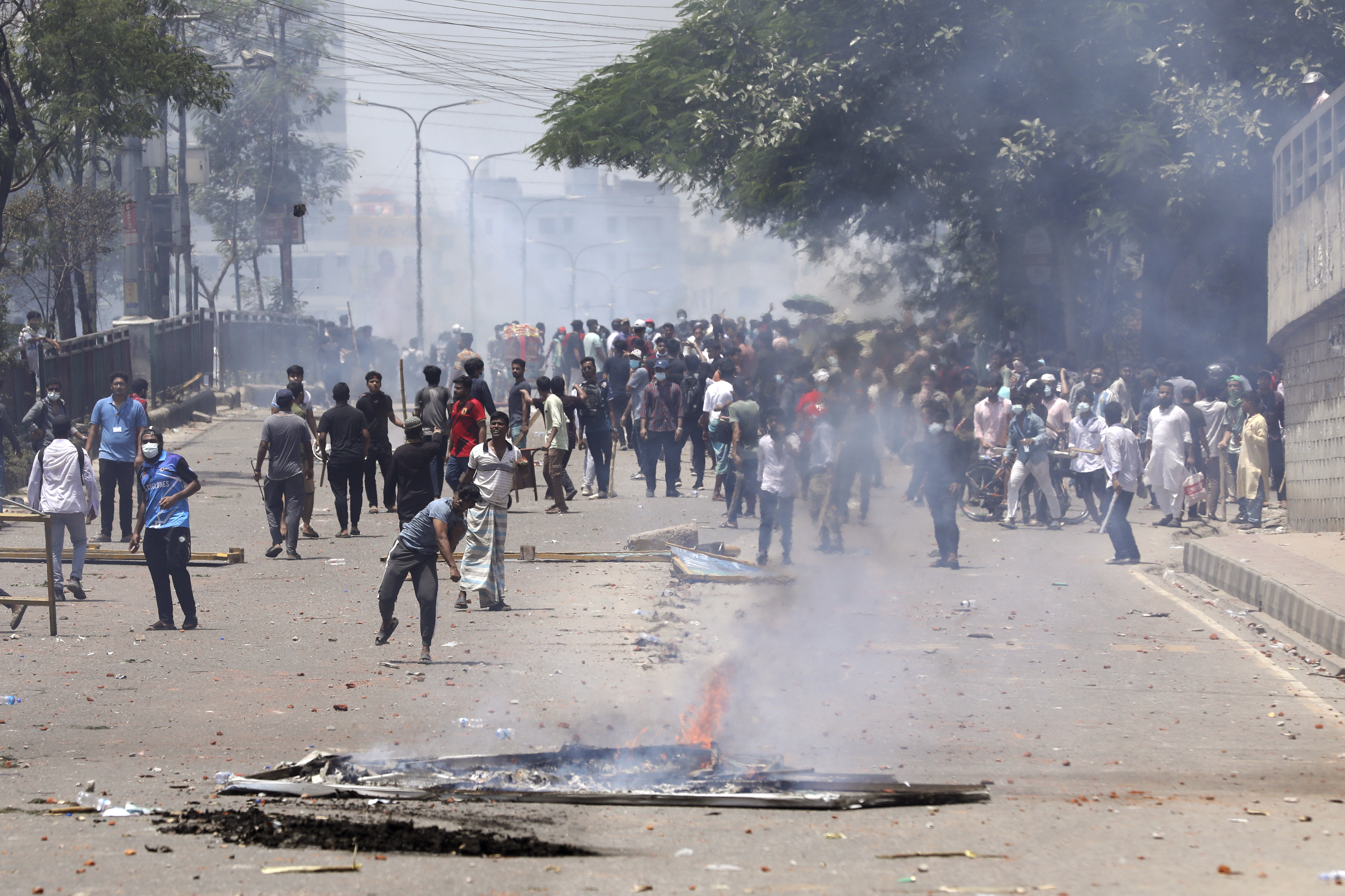 Students clash with riot police during a protest against a quota system for government jobs, in Dhaka, Bangladesh, Thursday, July 18, 2024. (AP Photo/Rajib Dhar)