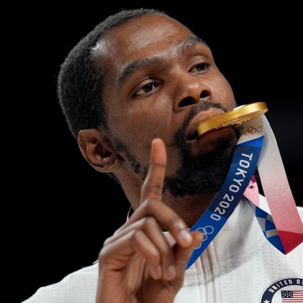 FILE - Kevin Durant poses for a photo with his gold medal during the medal ceremony for basketball game at the 2020 Summer Olympics, Aug. 7, 2021, in Tokyo, Japan. (AP Photo/Eric Gay, File)