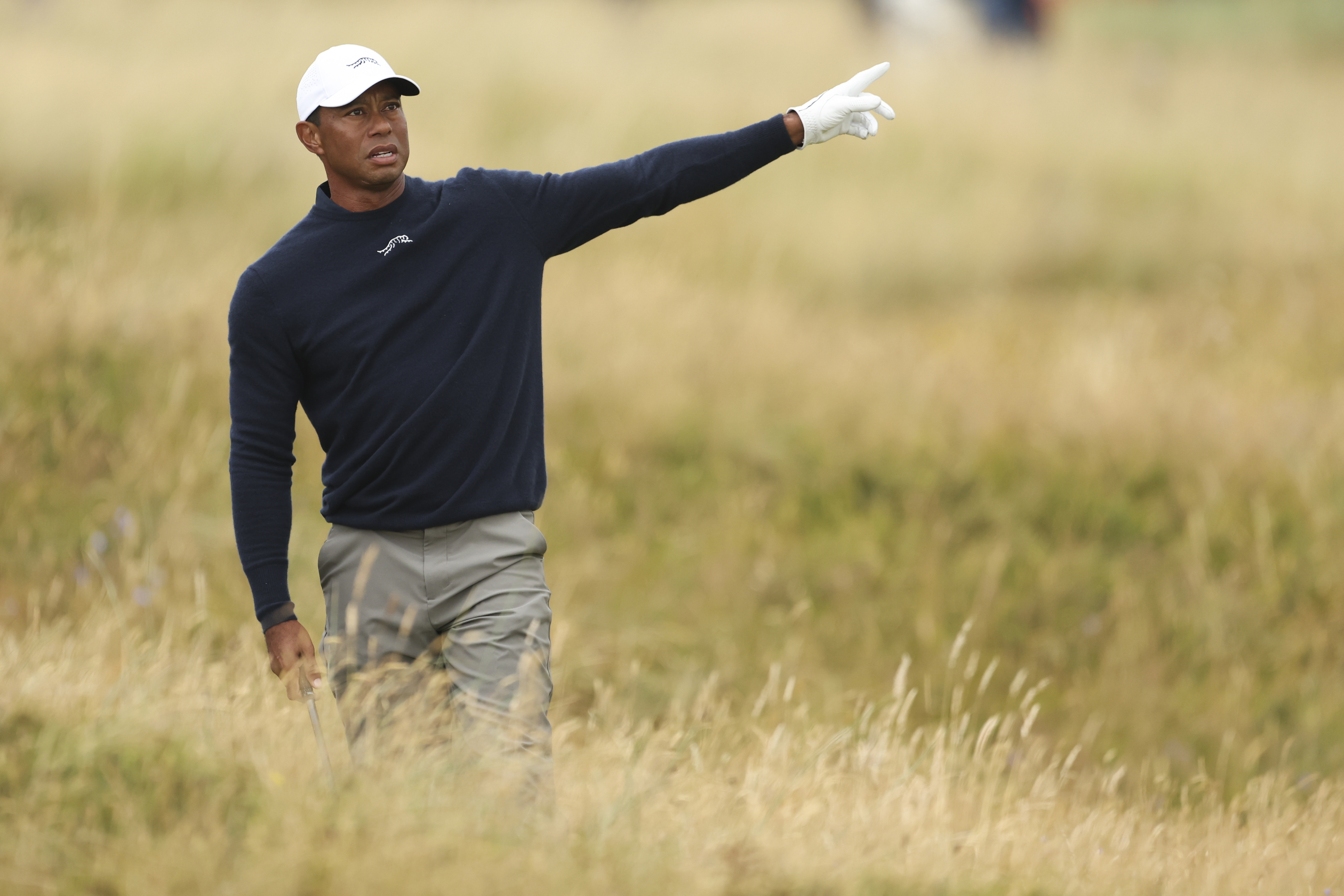 Tiger Woods of the United States gestures after playing from the rough on the sixth hole during his second round of the British Open Golf Championships at Royal Troon golf club in Troon, Scotland, Friday, July 19, 2024. (AP Photo/Peter Morrison)