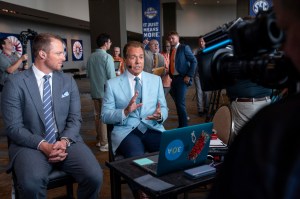 ESPN commentators Nick Saban, right, and Greg McElroy speak during the Southeastern Conference NCAA college football media days Wednesday, July 17, 2024, in Dallas. (AP Photo/Jeffrey McWhorter)