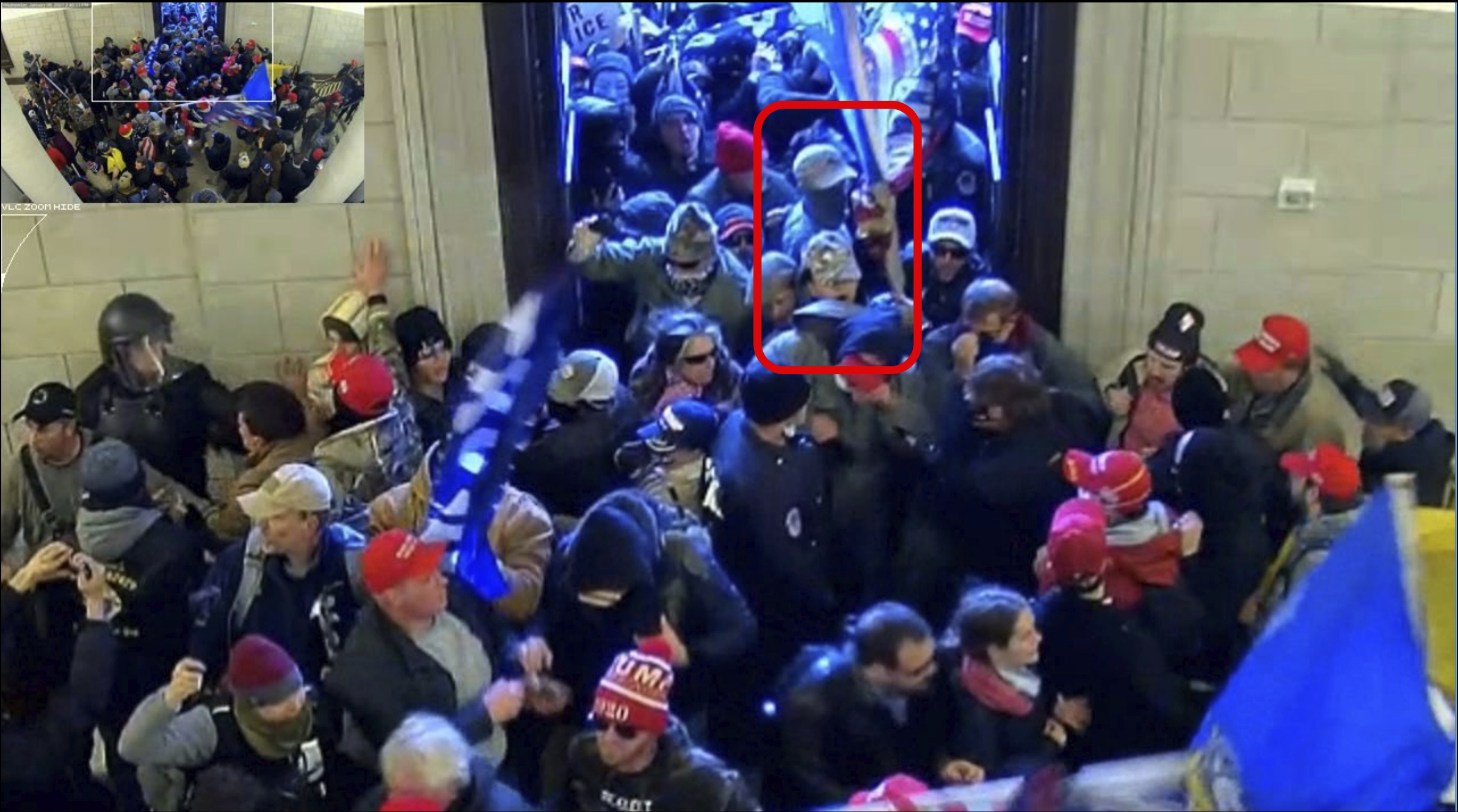 This image from U.S. Capitol Police security video and contained in the government's sentencing memorandum for Tyler Bradley Dykes, marked in red by source, shows him in the U.S. Capitol on Jan. 6, 2021, in Washington. Dykes, a South Carolina resident and active Marine accused of flashing a Nazi salute during the insurrection, has been sentenced to nearly five years in prison for assaulting police officers who were guarding the building. Dykes grabbed a police riot shield from the hands of two police officers and used it to push his way through police lines at the Capitol.(Department of Justice via AP)