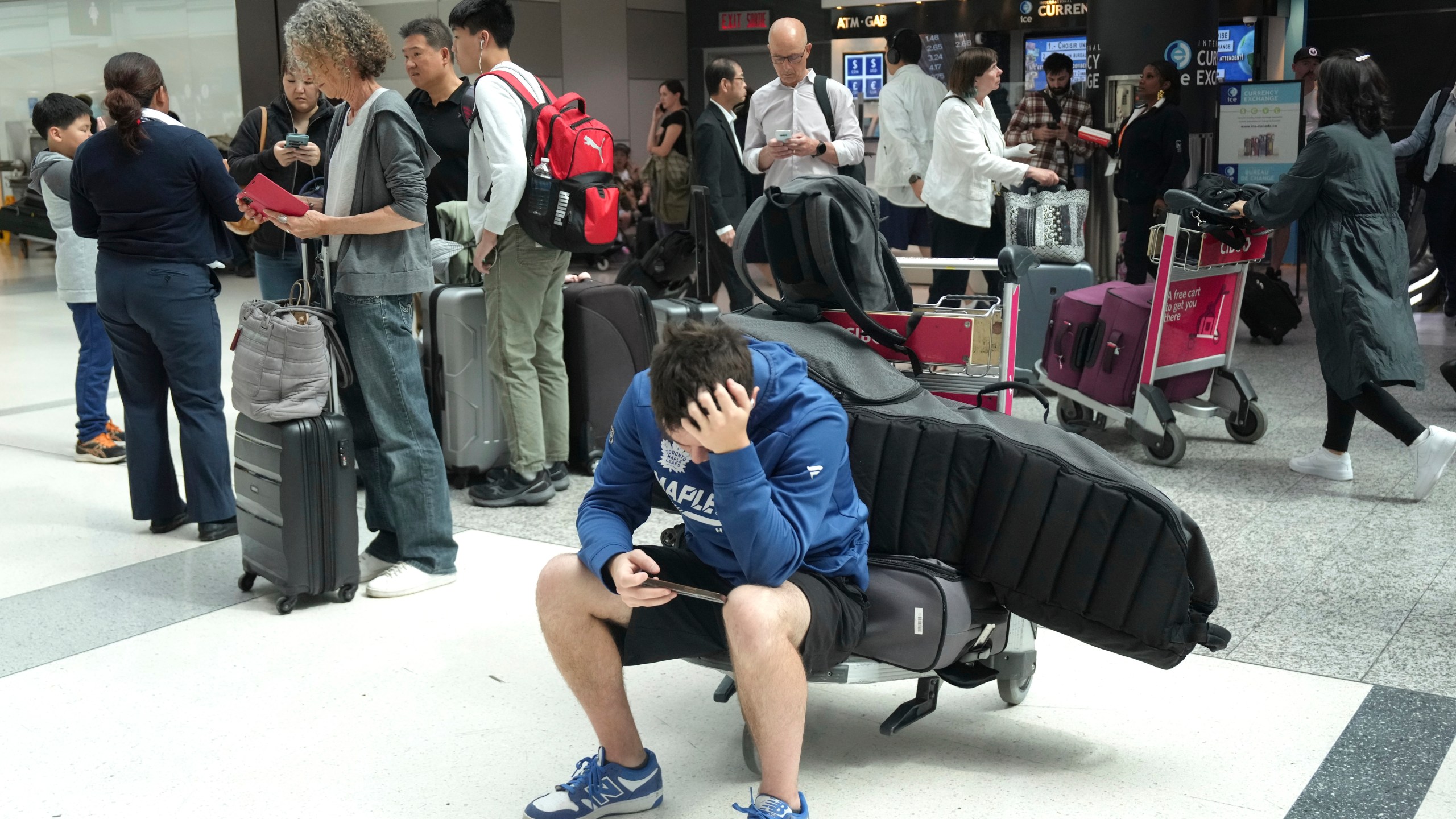 Porter Passengers wait at Toronto Pearson Airport on Friday, July 19, 2024, after a faulty CrowdStrike update affected computers running Microsoft Windows, causing a major internet outage. (Chris Young/The Canadian Press via AP)