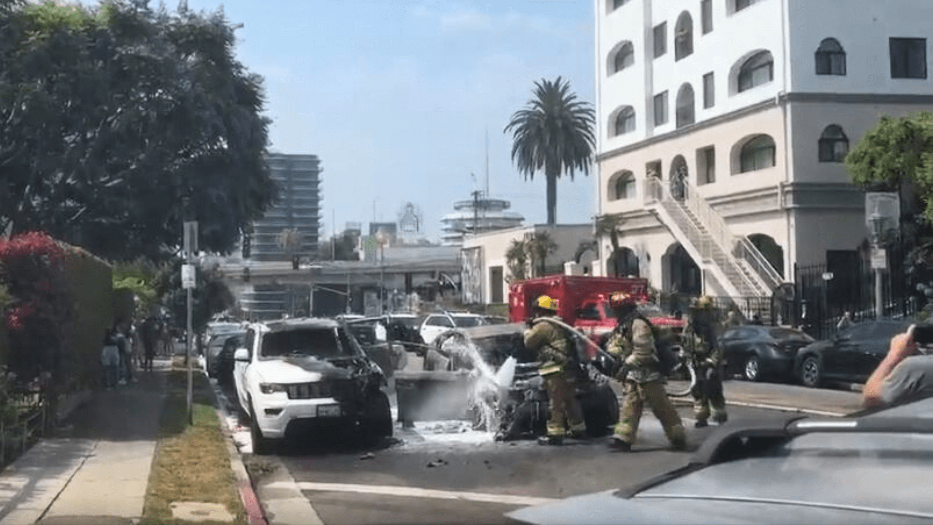 Firefighters extinguished two burning vehicles that were set ablaze by a woman in the Hollywood Hills on July 13, 2024. (Citizen)