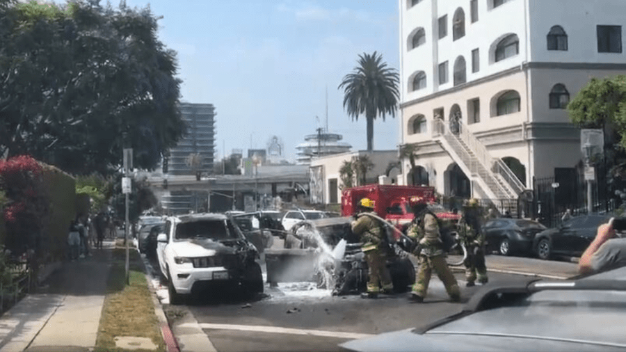 Firefighters extinguished two burning vehicles that were set ablaze by a woman in the Hollywood Hills on July 13, 2024. (Citizen)