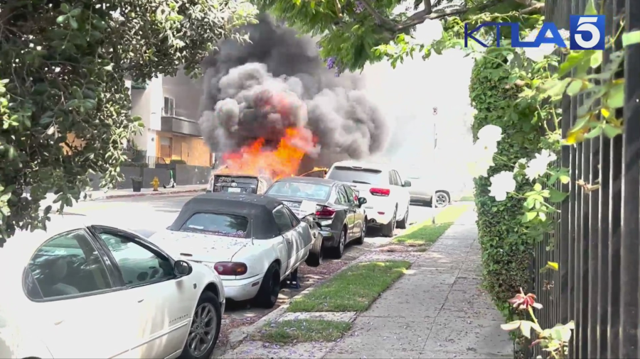 A vehicle was engulfed in flames after a woman set the car on fire during a violent rampage in the Hollywood Hills on July 13, 2024. (KTLA)