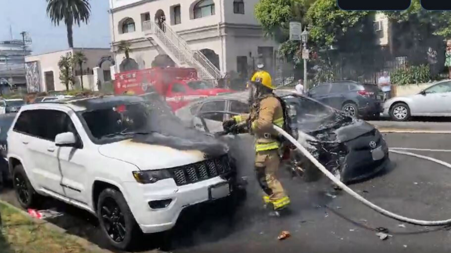 Firefighters extinguished two burning vehicles that were set ablaze by a woman in the Hollywood Hills on July 13, 2024. (Citizen)