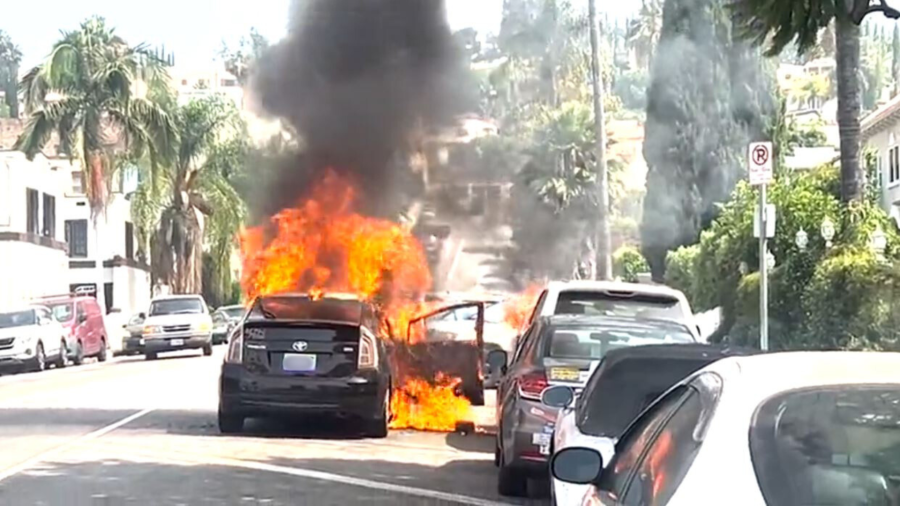 A vehicle was engulfed in flames after a woman set the car on fire during a violent rampage in the Hollywood Hills on July 13, 2024. (KTLA)