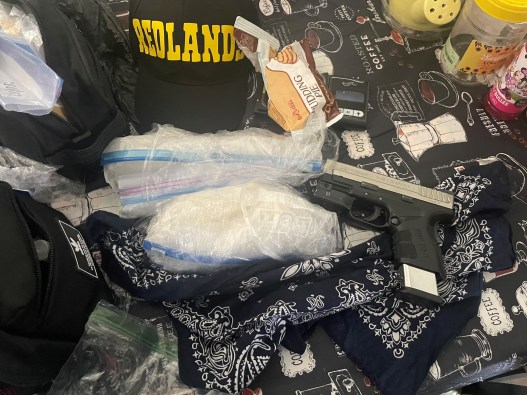 An array of drugs and a firearm are shown in this undated photo provided by the San Bernardino County Sheriff's Department. Drugs and firearms were recovered as part of a gang sweep in late June and early July 2024.