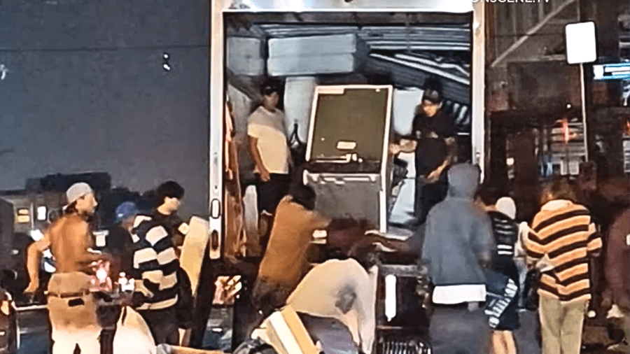 A moving van full of furniture is unloaded on Skid Row