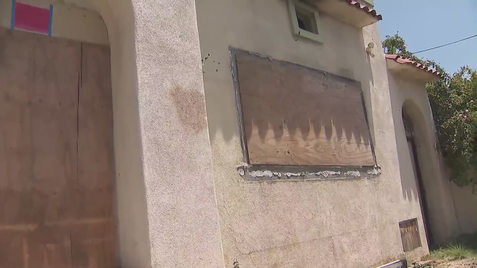 A West Hollywood home remains boarded up on July 2, 2024 after a large fire was ignited amid complaints of squatters constantly trespassing. (KTLA)