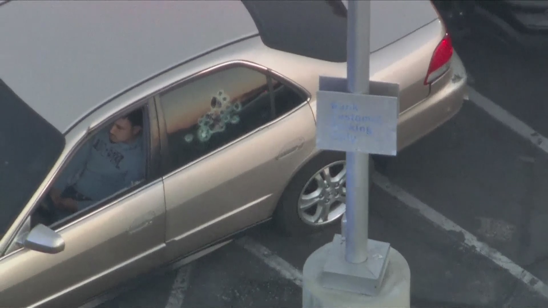 The suspects refused to get out as patrol cars boxed in the suspect's vehicle in a Compton parking lot on July 5, 2024. (KTLA)