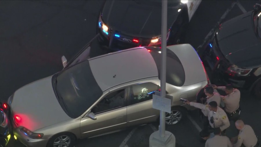 Deputies checking the vehicle for additional suspects inside after the driver and passenger surrendered in Compton on July 5, 2024. (KTLA)