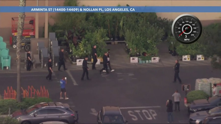 The suspect was taken into custody after police found him inside the Home Depot store. He had taken off a yellow sweater in an attempt to blend in. (KTLA)