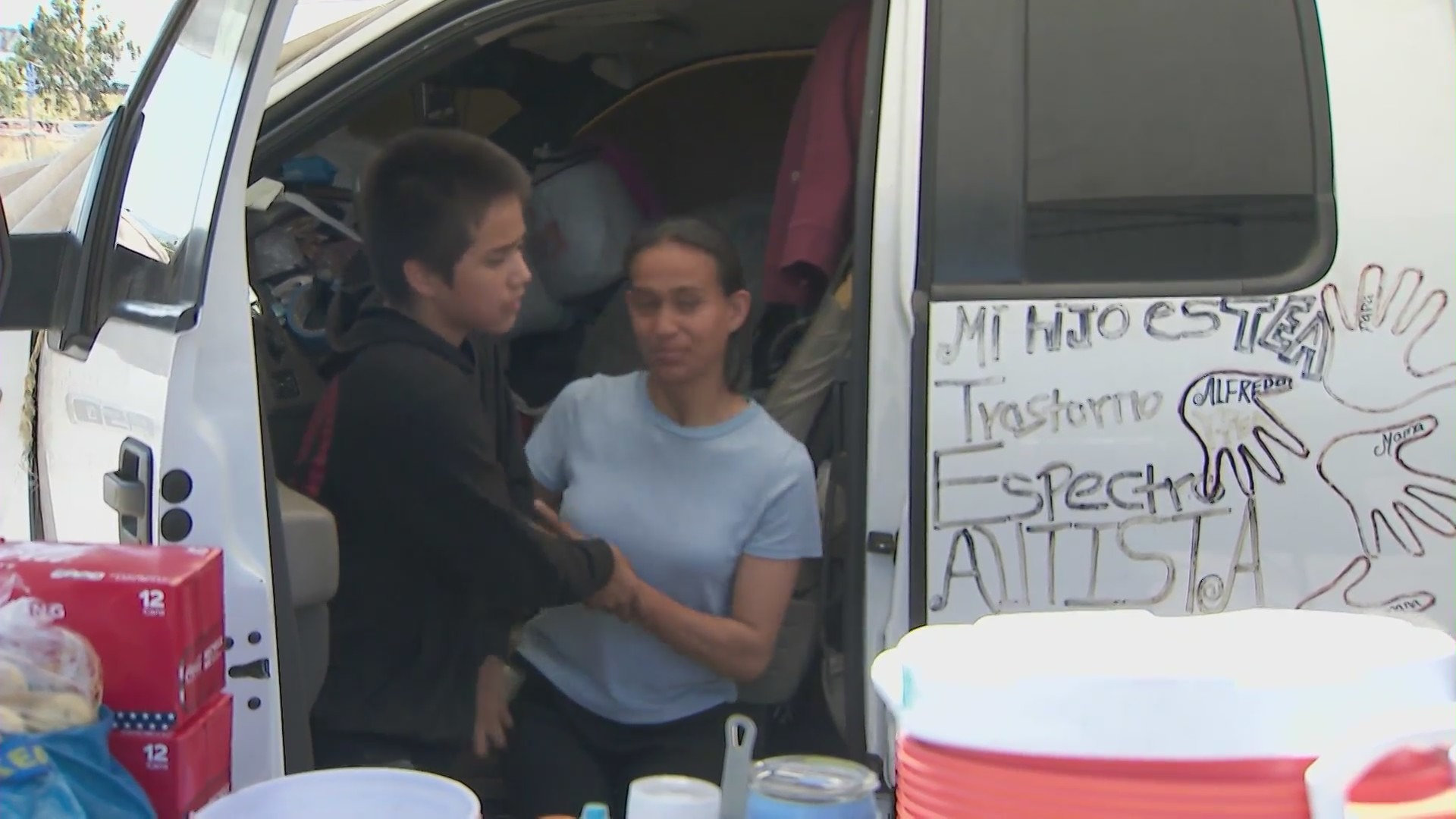 Alfredo Morales and his sister is seen outside the truck they live in with their family at a Pacoima park. (KTLA)