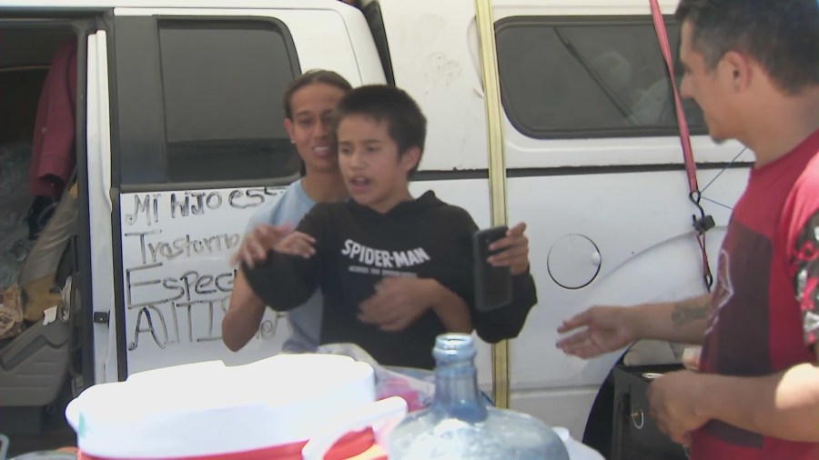 The Morales family, who are homeless, are seen spending an afternoon together outside of the truck they live in at a Pacoima park on July 4, 2024. (KTLA)