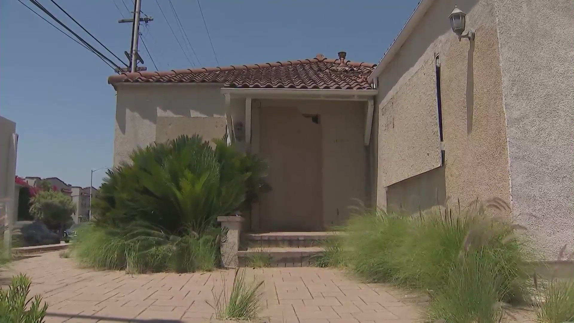 A West Hollywood home remains boarded up on July 2, 2024 after a large fire was ignited amid complaints of squatters constantly trespassing. (KTLA)