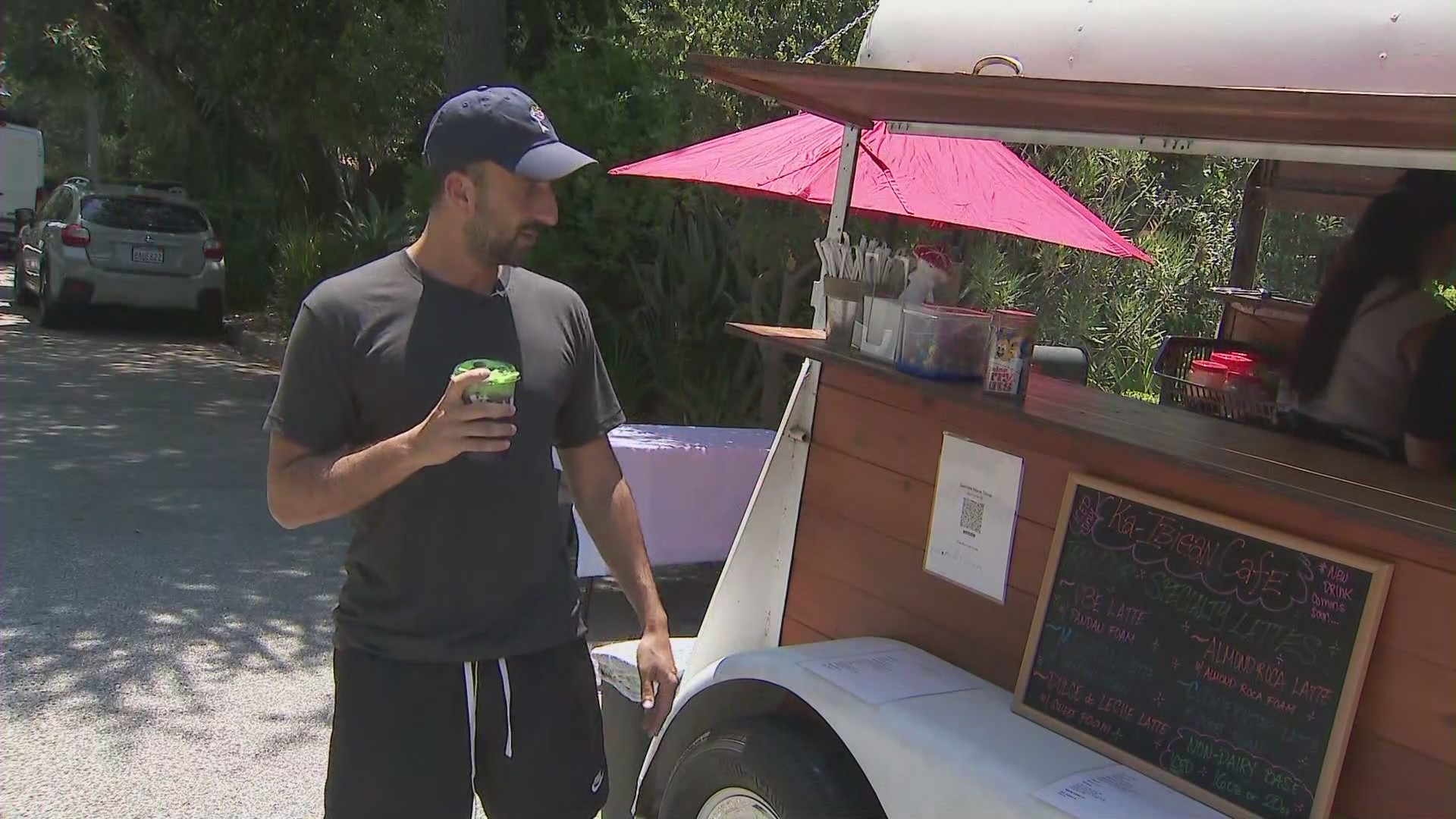 Customers enjoying drinks from the Ka-Ibigan Cafe coffee cart in Altadena on July 9, 2024. (KTLA)