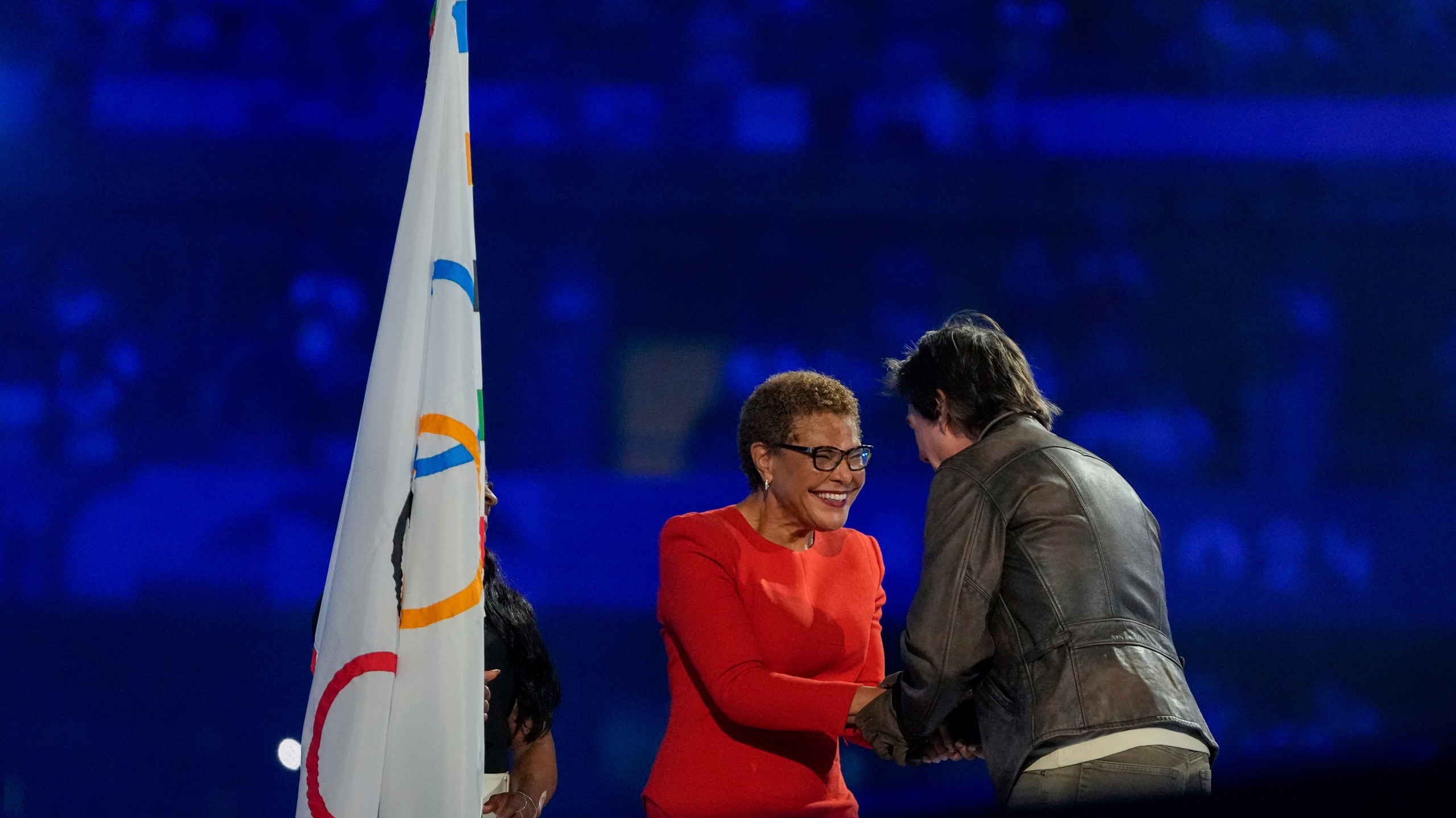 Tom Cruise greets Los Angeles Mayor Karen Bass during the 2024 Summer Olympics closing ceremony at the Stade de France, Sunday, Aug. 11, 2024, in Saint-Denis, France. (AP Photo/Natacha Pisarenko)