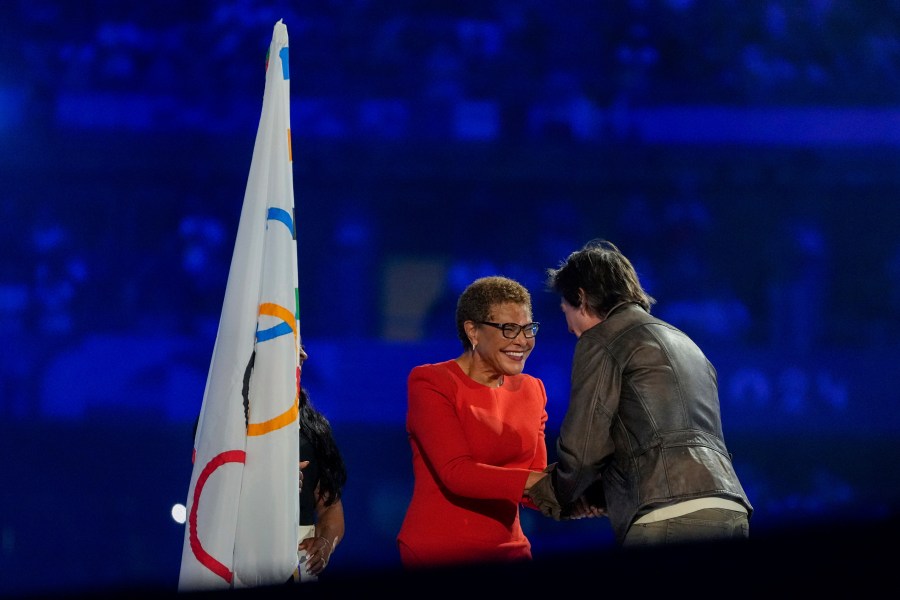 Tom Cruise greets Los Angeles Mayor Karen Bass during the 2024 Summer Olympics closing ceremony at the Stade de France, Sunday, Aug. 11, 2024, in Saint-Denis, France. (AP Photo/Natacha Pisarenko)