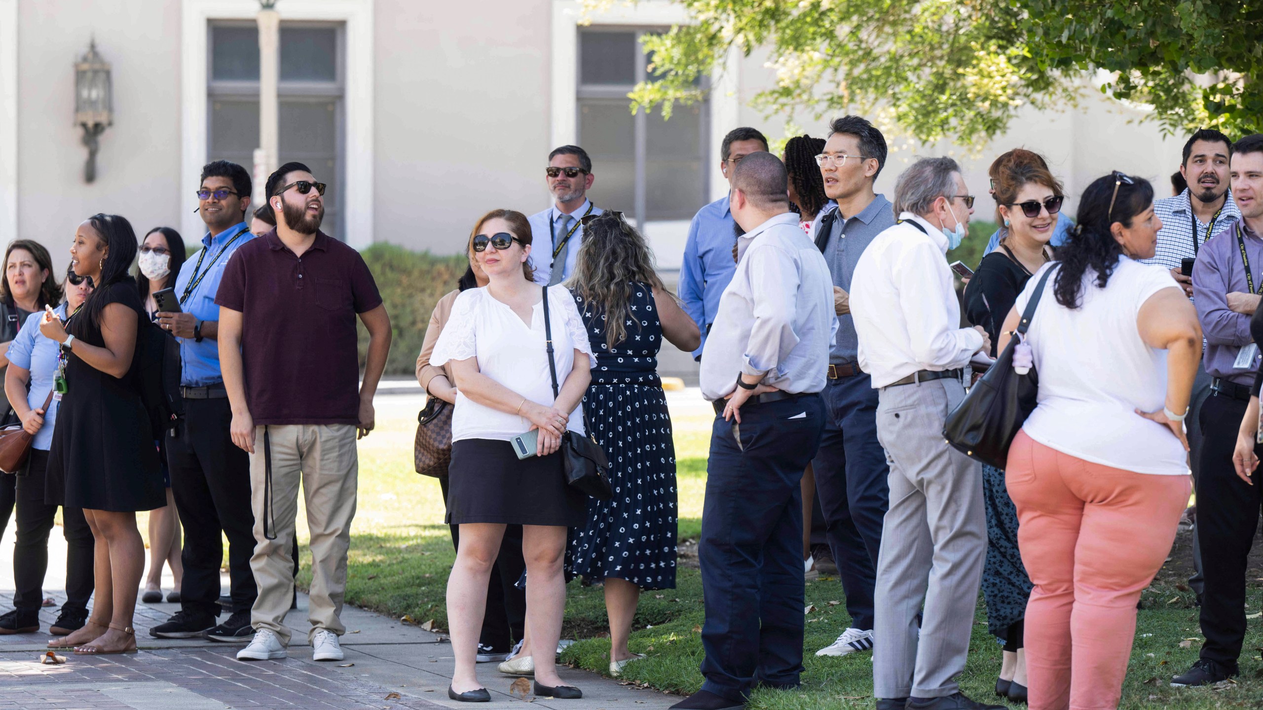 People wait to reenter Pasadena City Hall on Monday, Aug. 12, 2024, in Pasadena, Calif., after an earthquake was strongly felt from the Los Angeles area all the way to San Diego. (Sarah Reingewirtz/The Orange County Register via AP)