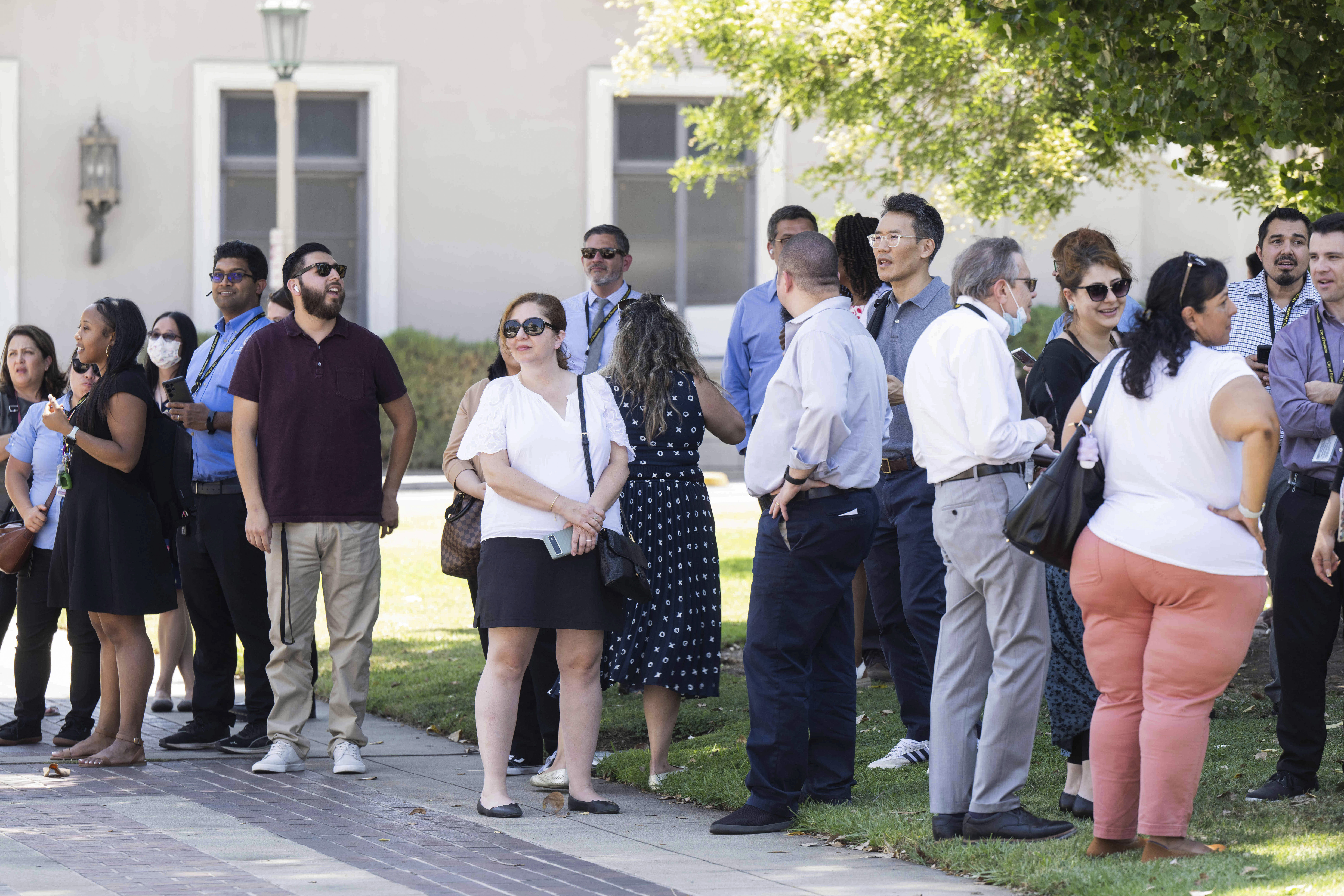 People wait to reenter Pasadena City Hall on Monday, Aug. 12, 2024, in Pasadena, Calif., after an earthquake was strongly felt from the Los Angeles area all the way to San Diego. (Sarah Reingewirtz/The Orange County Register via AP)