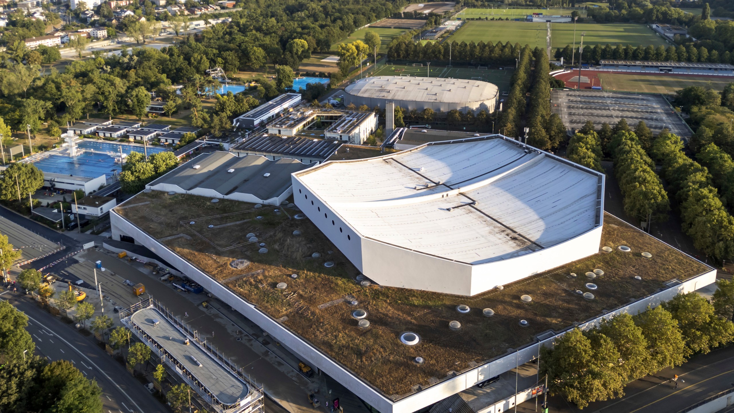 The St. Jakobshalle arena, front, which is the venue for the Eurovision Song Contest 2025 is seen, in Basel, Wednesday Aug. 28, 2024. (Georgios Kefalas/Keystone via AP)