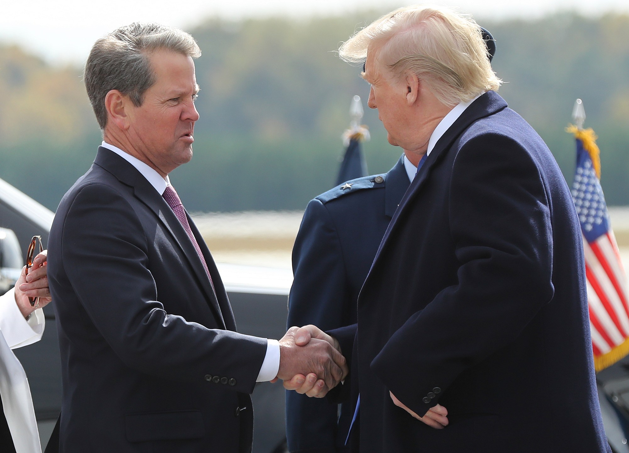 FILE - Georgia Gov. Brian Kemp, left, greets President Donald Trump as he arrives at Dobbins Air Reserve Base, Nov. 8, 2019, in Marietta, Ga. (Curtis Compton/Atlanta Journal-Constitution via AP, File)