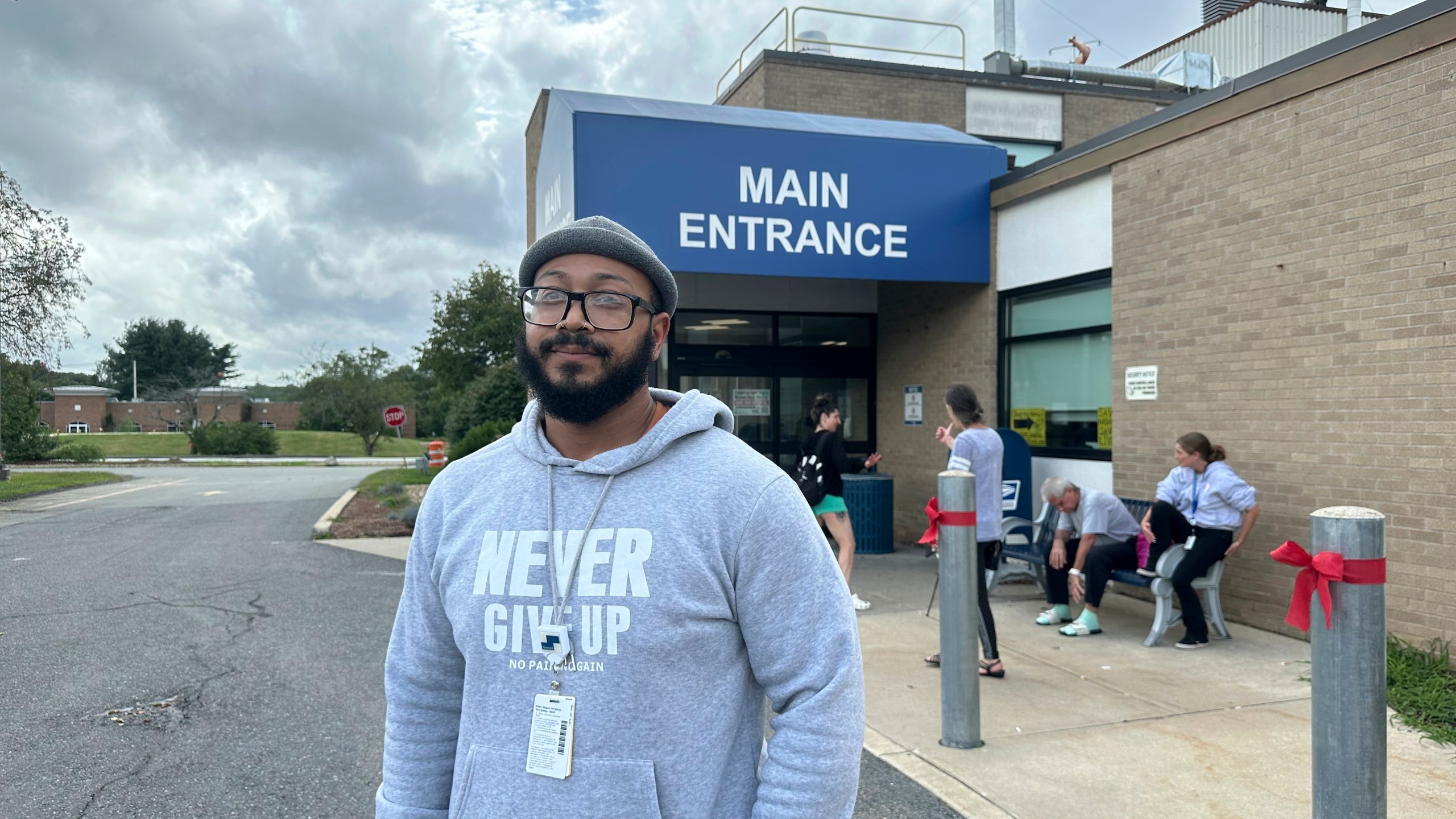 Michael Santos, a security guard, stands outside the Nashoba Valley Medical Center in Ayer, Mass., on Friday, Aug. 9, 2024. (AP Photo/Nick Perry)